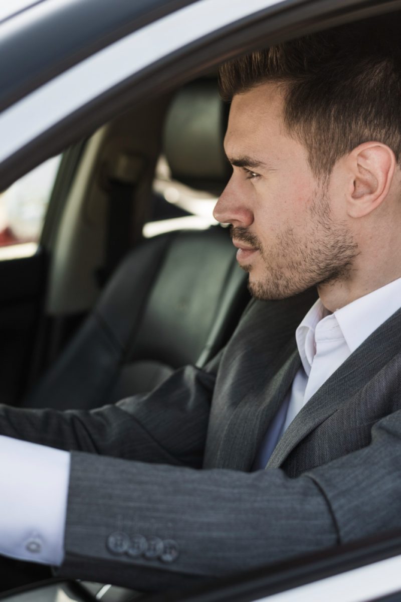 stylish-young-businessman-driving-car stylish-young-businessman-driving-car
